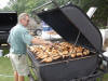 Grillmaster Brent Durst helps out the lodge and checks a batch of chickens.