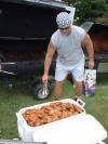Brother Ronnie Siegler unloads a few chicken halves.