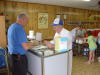 Brothers Dave Lantz and George Norris confer on ticket sales.