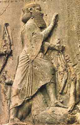 A close up of Darius 
the Great showing his feet on the body of Gaumata the false
 king; while holding his right hand up thanking Ahura Mazda for
 his triumph in saving his empire.